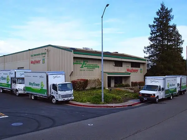 Five Farnsworth and Mayflower vans parked outside the Francisco Blvd warehouse