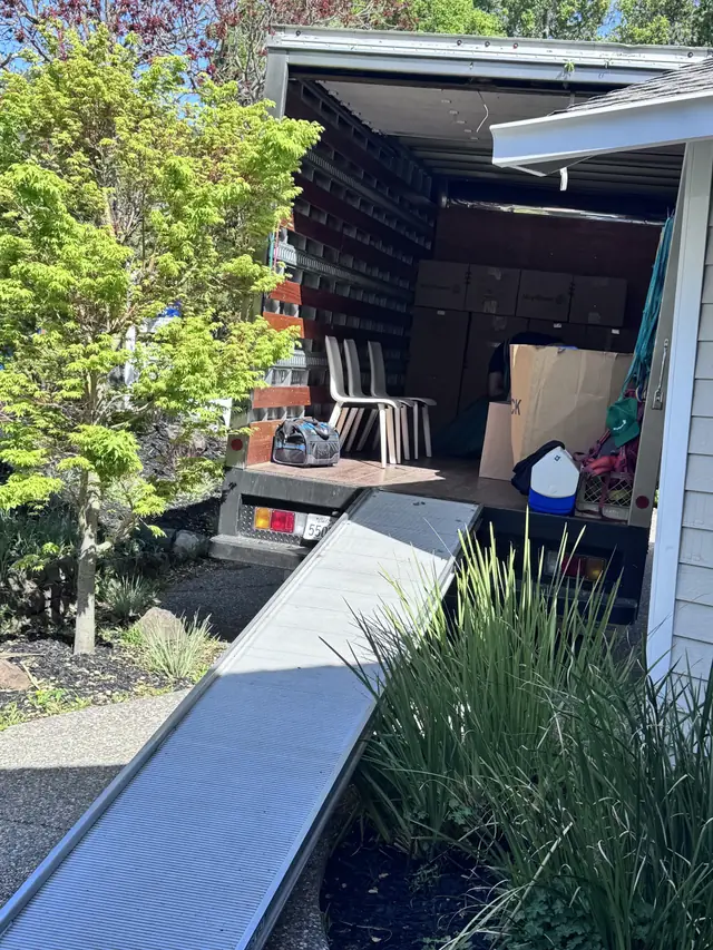 Farnsworth box truck backed to a Marin house with the loading ramp down to the front path